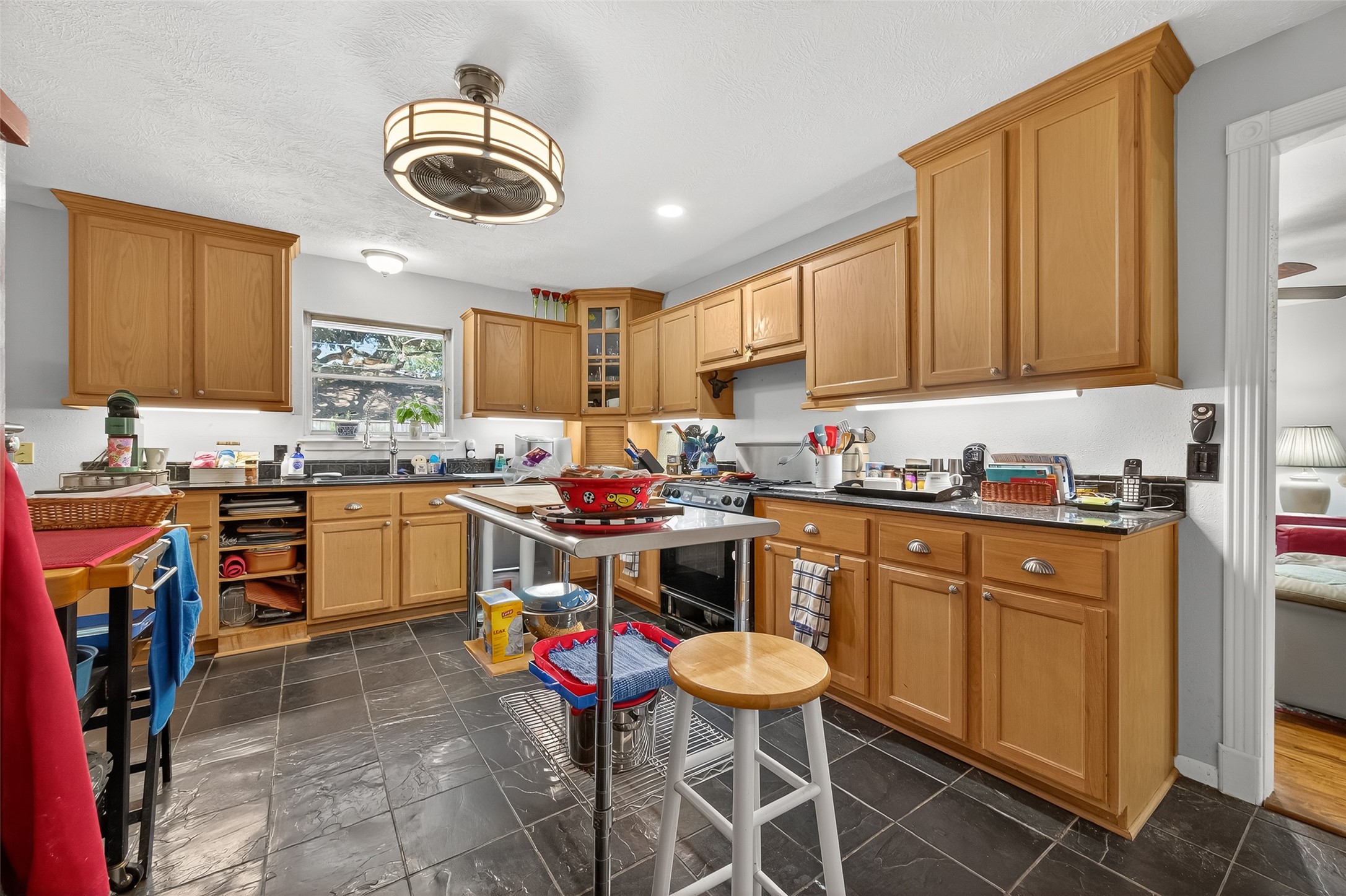 5326 Redstart Street Houston, TX 77096 - Photo 3 of 41 a kitchen with a sink cabinets and window