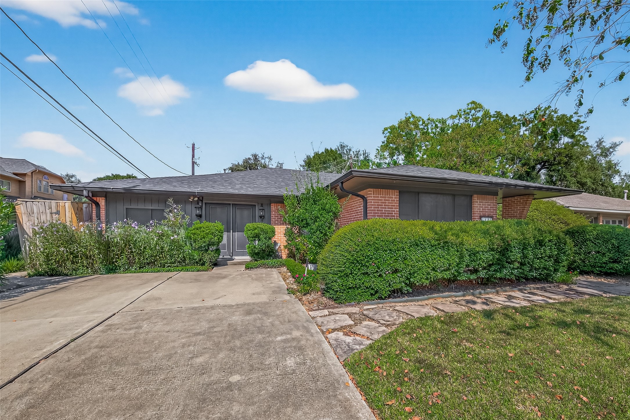 5326 Redstart Street Houston, TX 77096 - Photo 35 of 41 a front view of a house with a yard and potted plants