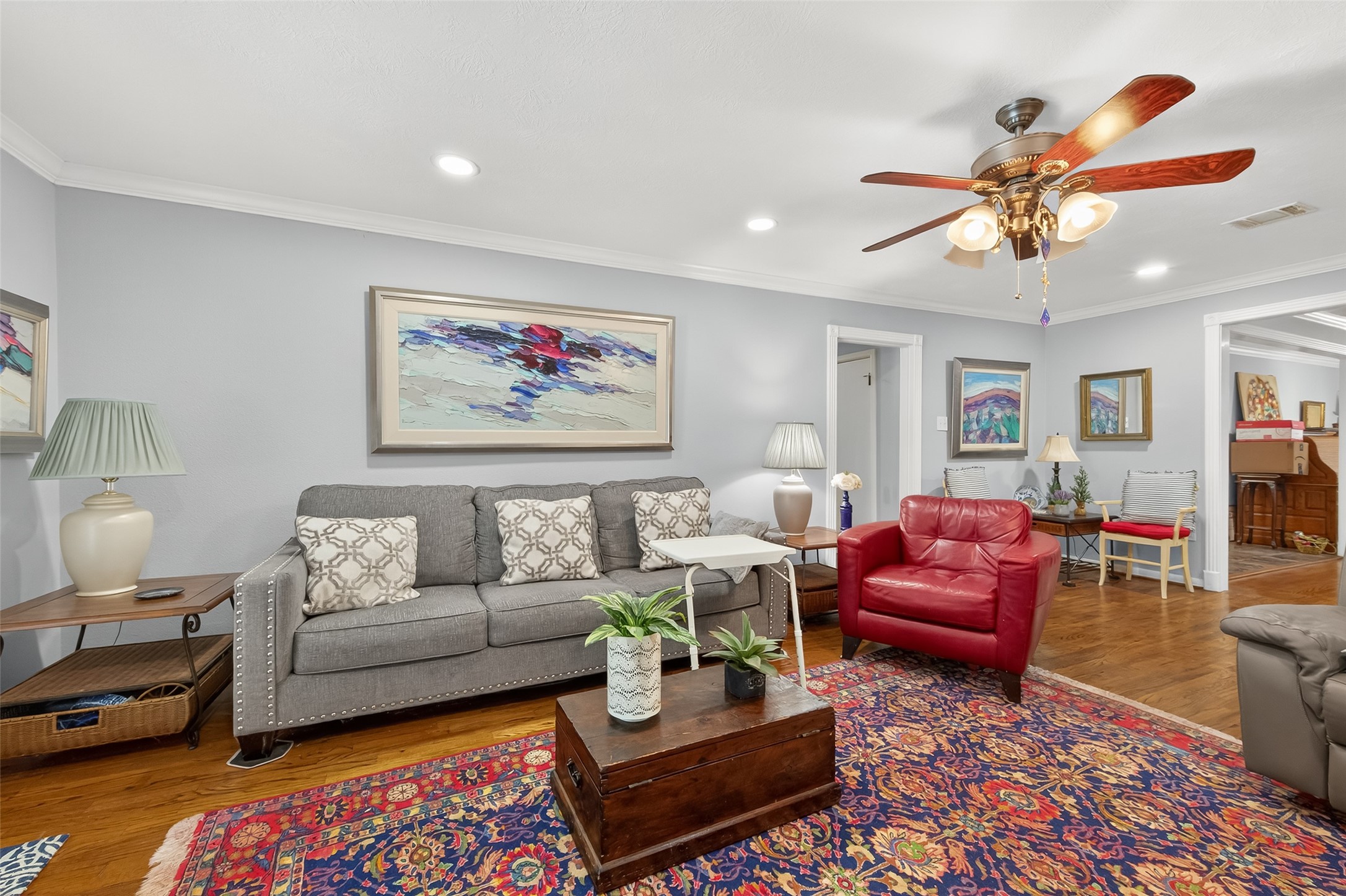 5326 Redstart Street Houston, TX 77096 - Photo 8 of 41 a living room with furniture a rug and a chandelier