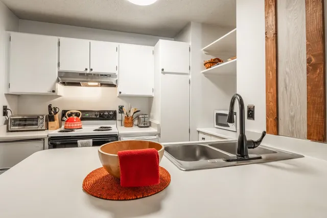 a kitchen with a table and chairs in it