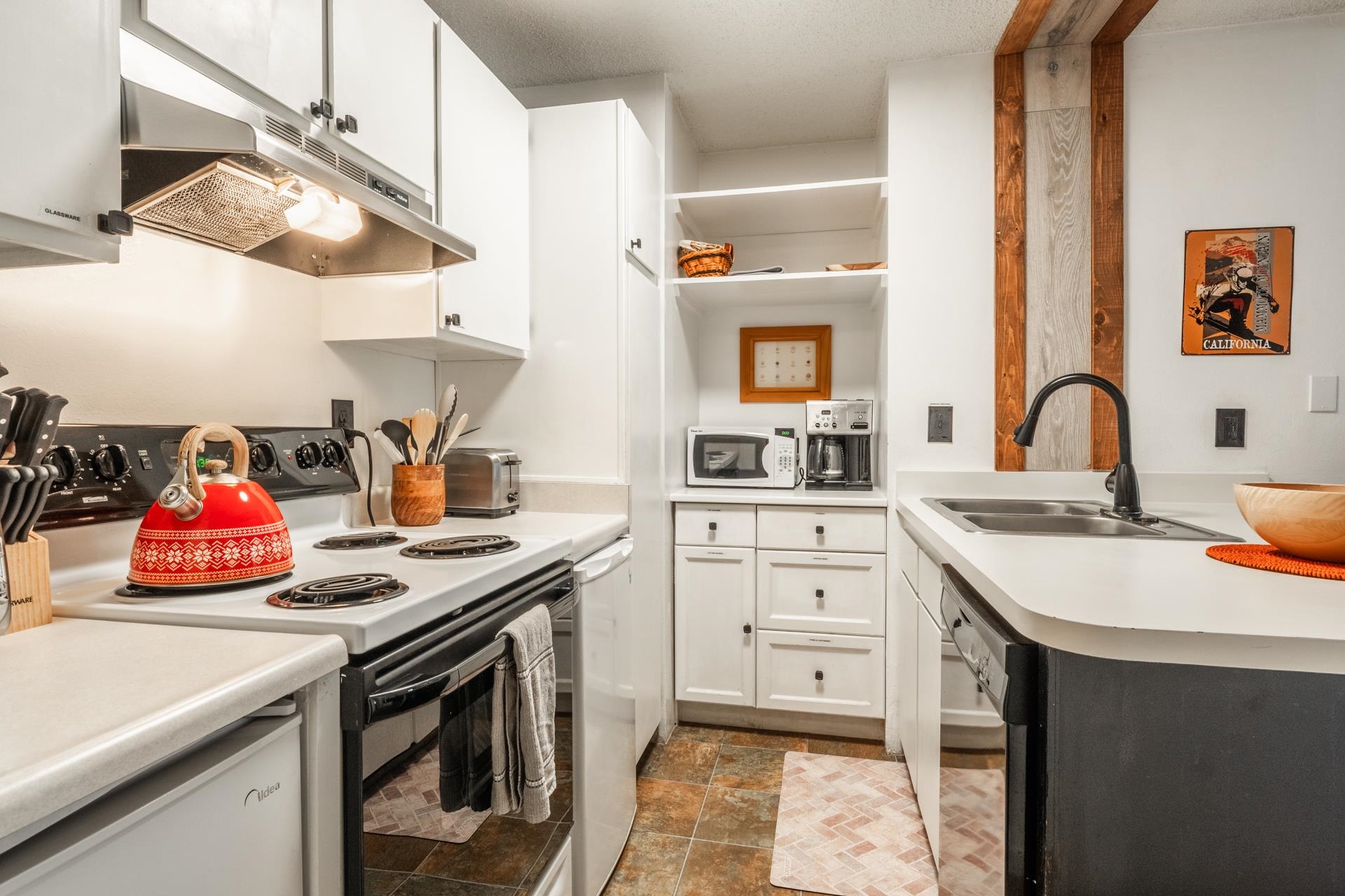 2499 Sierra Nevada Road, Unit R2 Mammoth Lakes, CA 93546 - Photo 12 of 28 a kitchen with a sink dishwasher and cabinets with wooden floor