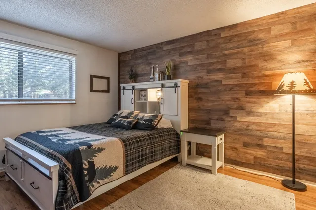 a kitchen with a sink dishwasher and cabinets with wooden floor