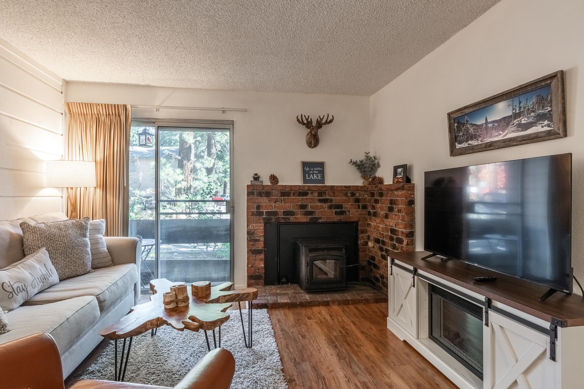 2499 Sierra Nevada Road, Unit R2 Mammoth Lakes, CA 93546 - Photo 6 of 28 a living room with furniture a flat screen tv and a fireplace