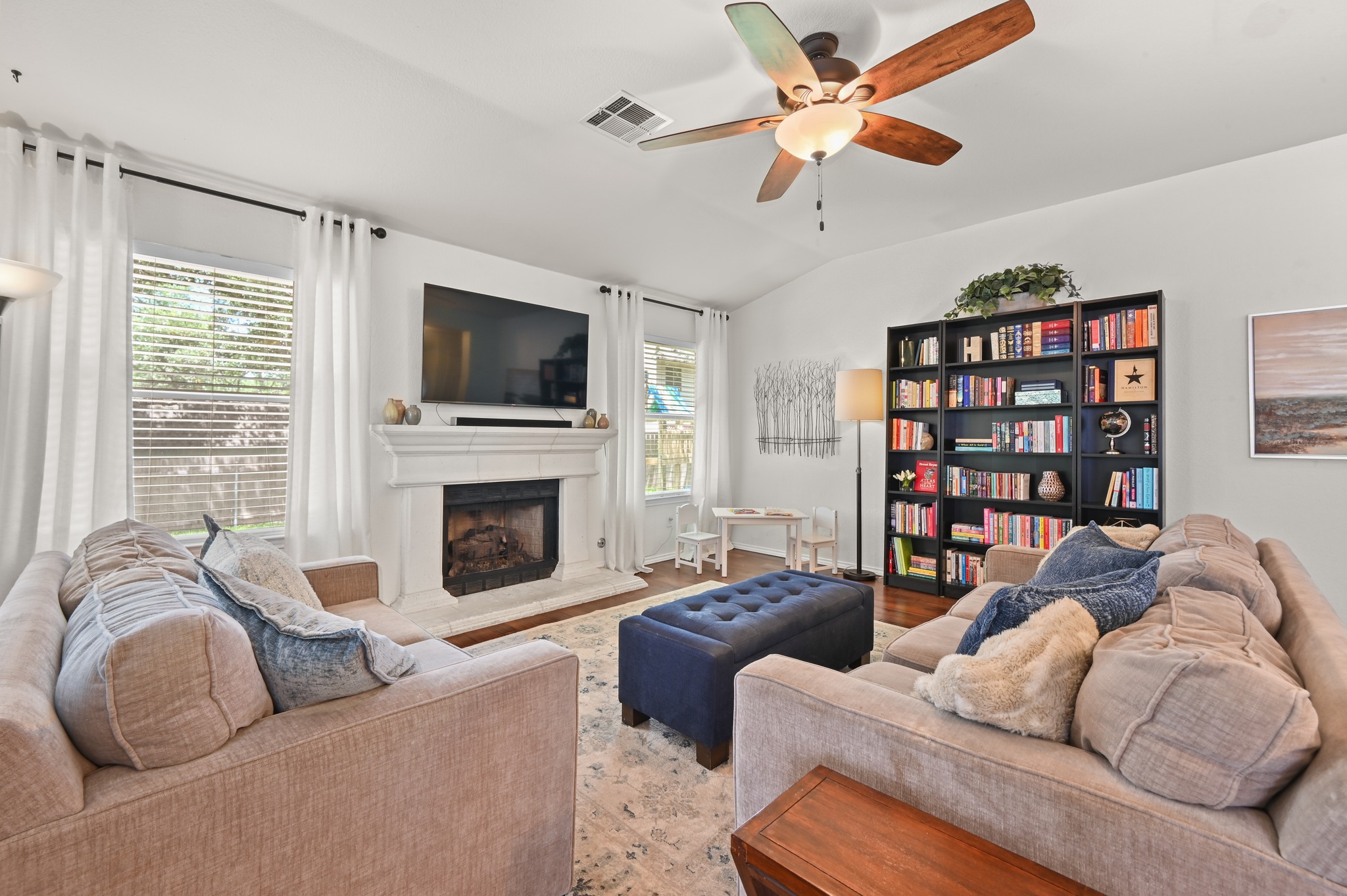 1409 Knoll Ridge Drive Cedar Park, TX 78613 - Photo 10 of 30 A welcoming living area with a cozy fireplace, well-appointed built-in features, and a lofty ceiling.