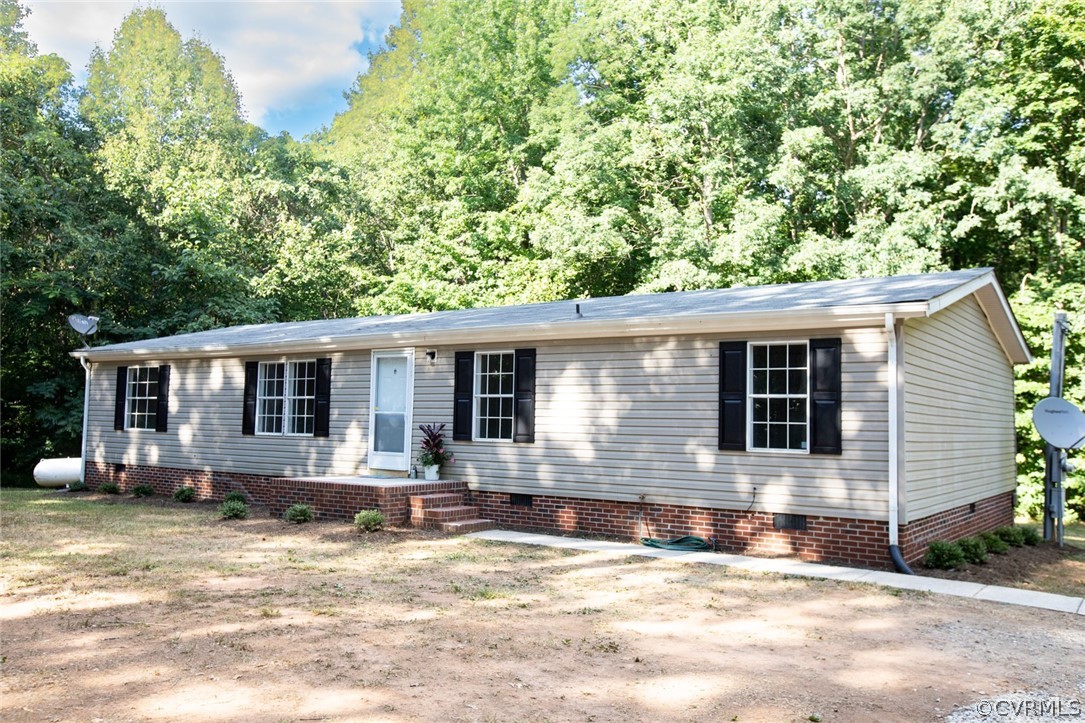 167 Browntown Road Prospect, VA 23960 - Photo 2 of 40 a front view of house with yard and trees in the background