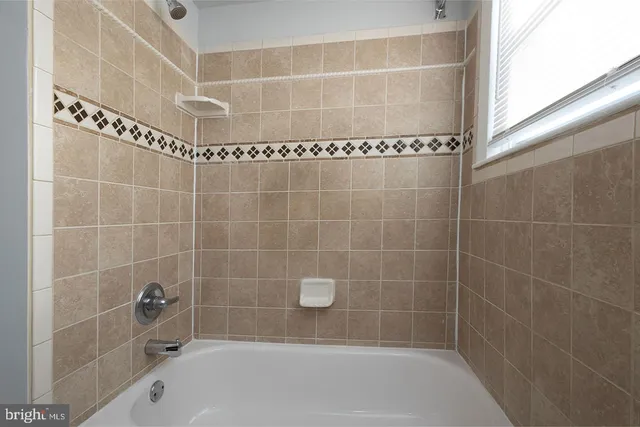 a white toilet sitting next to a bath tub