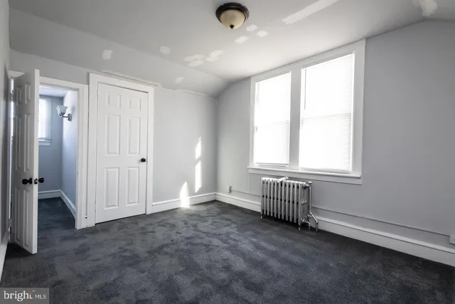 a view of an empty room and closet area