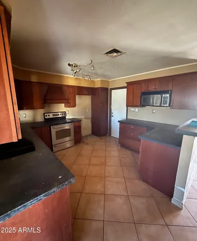 a kitchen with a cabinets and stainless steel appliances
