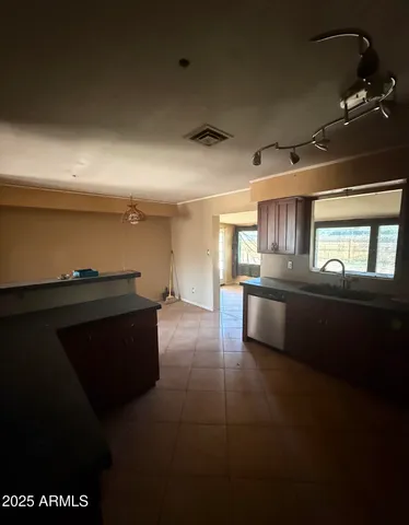 a kitchen with granite countertop a stove and cabinets