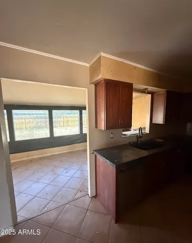 a kitchen with a sink cabinets and a window