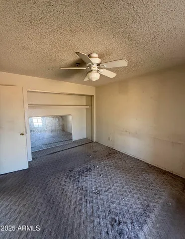 a view of empty room with ceiling fan