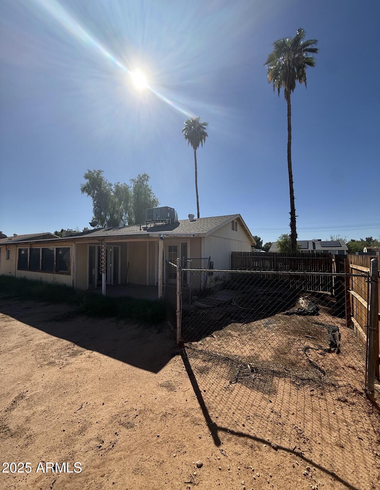 2615 North Yucca Street Chandler, AZ 85224 - Photo 32 of 38 a bedroom with bed and a chandelier