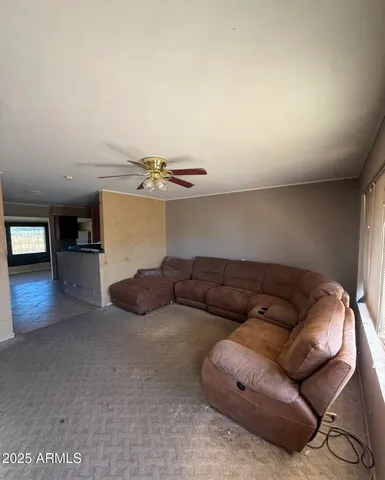 a living room with furniture and kitchen view