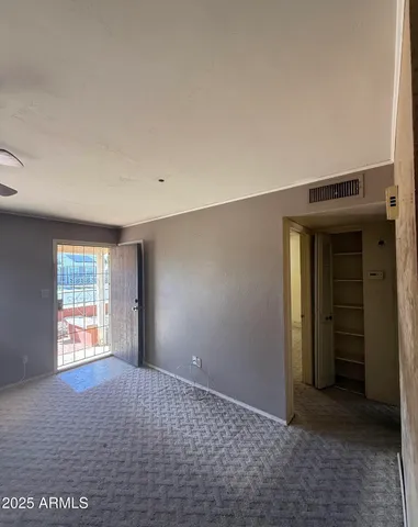 an empty room with windows and closet