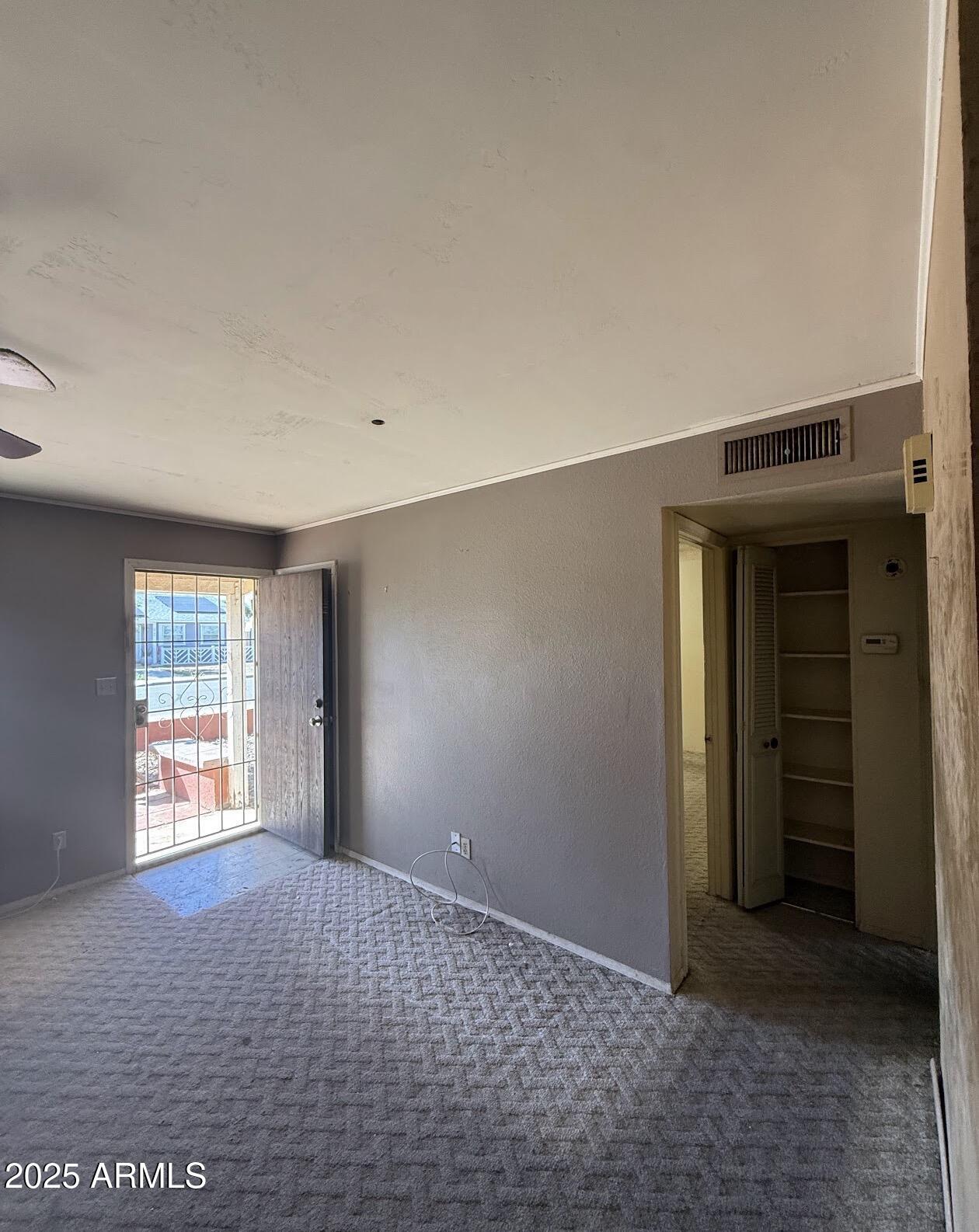 2615 North Yucca Street Chandler, AZ 85224 - Photo 7 of 38 an empty room with windows and closet