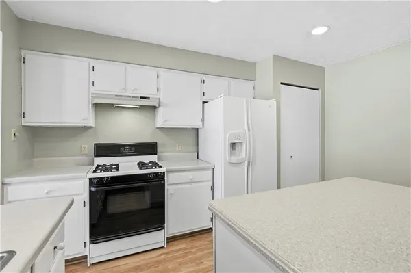 a kitchen with a stove and a refrigerator
