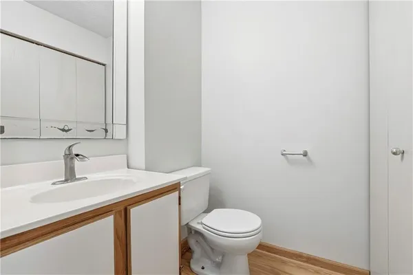 a bathroom with a sink a toilet and a mirror
