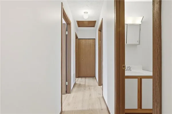 a view of a hallway with wooden floor