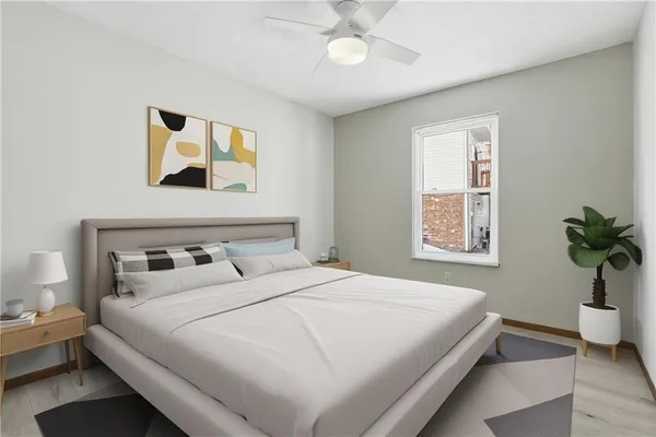 a bedroom with a large bed and a potted plant