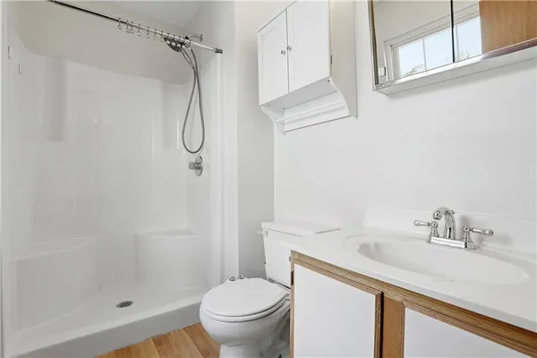 a bathroom with a sink toilet and shower