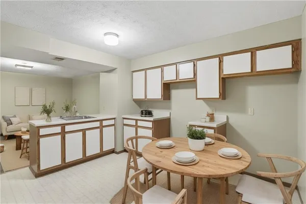 a kitchen with stainless steel appliances granite countertop a sink and cabinets with wooden floor