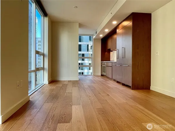 wooden floor in an empty room and a kitchen