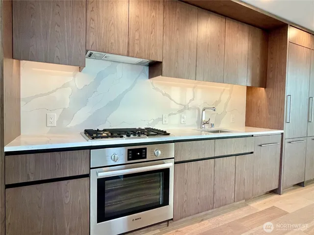 a stove top oven sitting inside of a kitchen