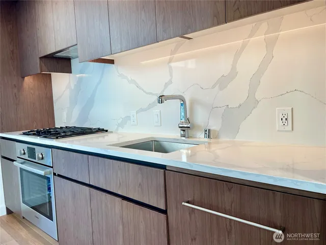 a kitchen with a sink and a refrigerator