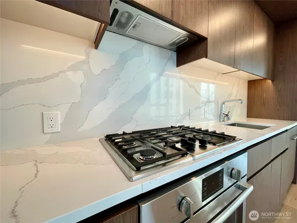 a stove top oven sitting inside of a kitchen