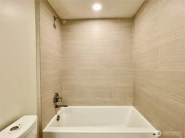 a bath tub sitting next to a white sink and a shower