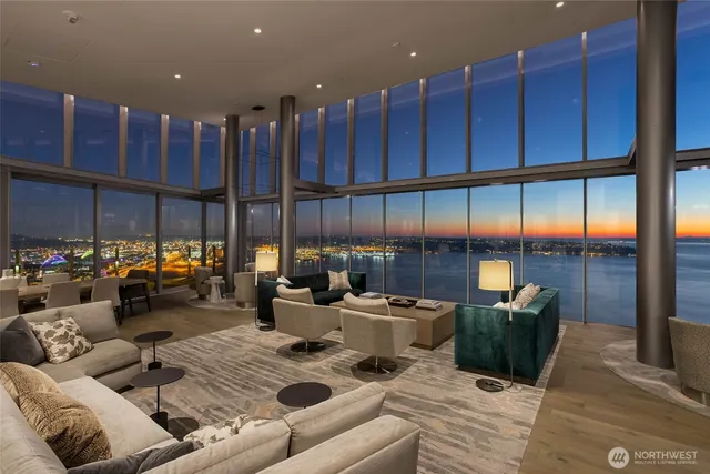 a living room with furniture kitchen view and a large window