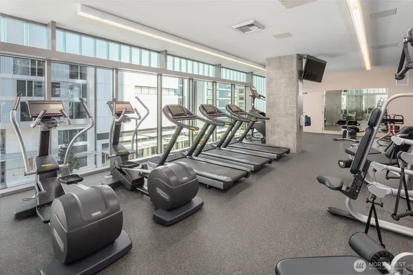 a room with gym equipment and a large window