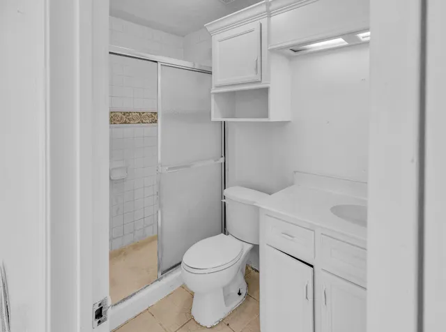 a bathroom with a toilet a sink and shower