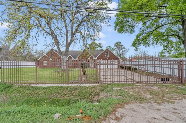 a view of a park with iron fence