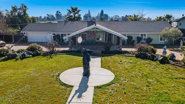 a aerial view of a house with swimming pool garden and patio