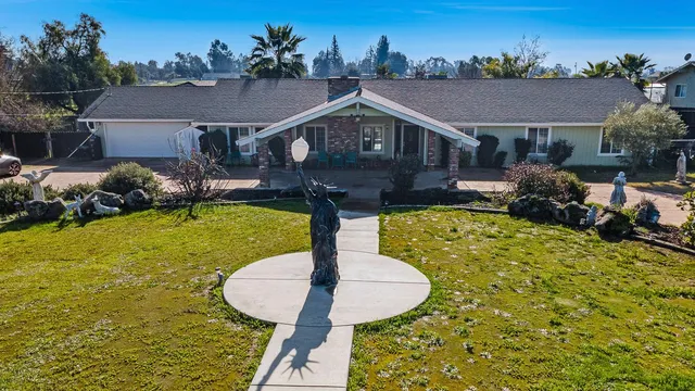 a aerial view of a house with swimming pool garden and patio