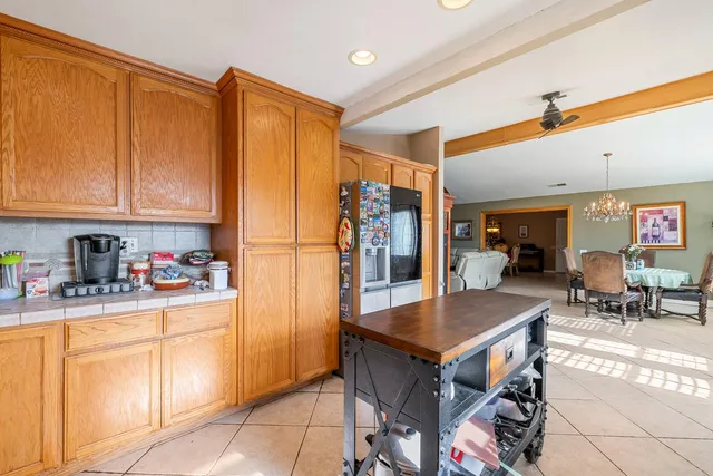 a kitchen with stainless steel appliances granite countertop a refrigerator and a stove top oven