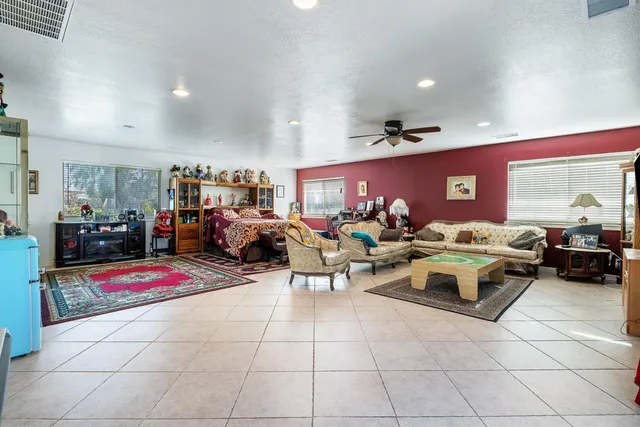 a living room with lots of furniture and a chandelier