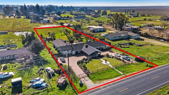 an outdoor space with seating area and a garden view