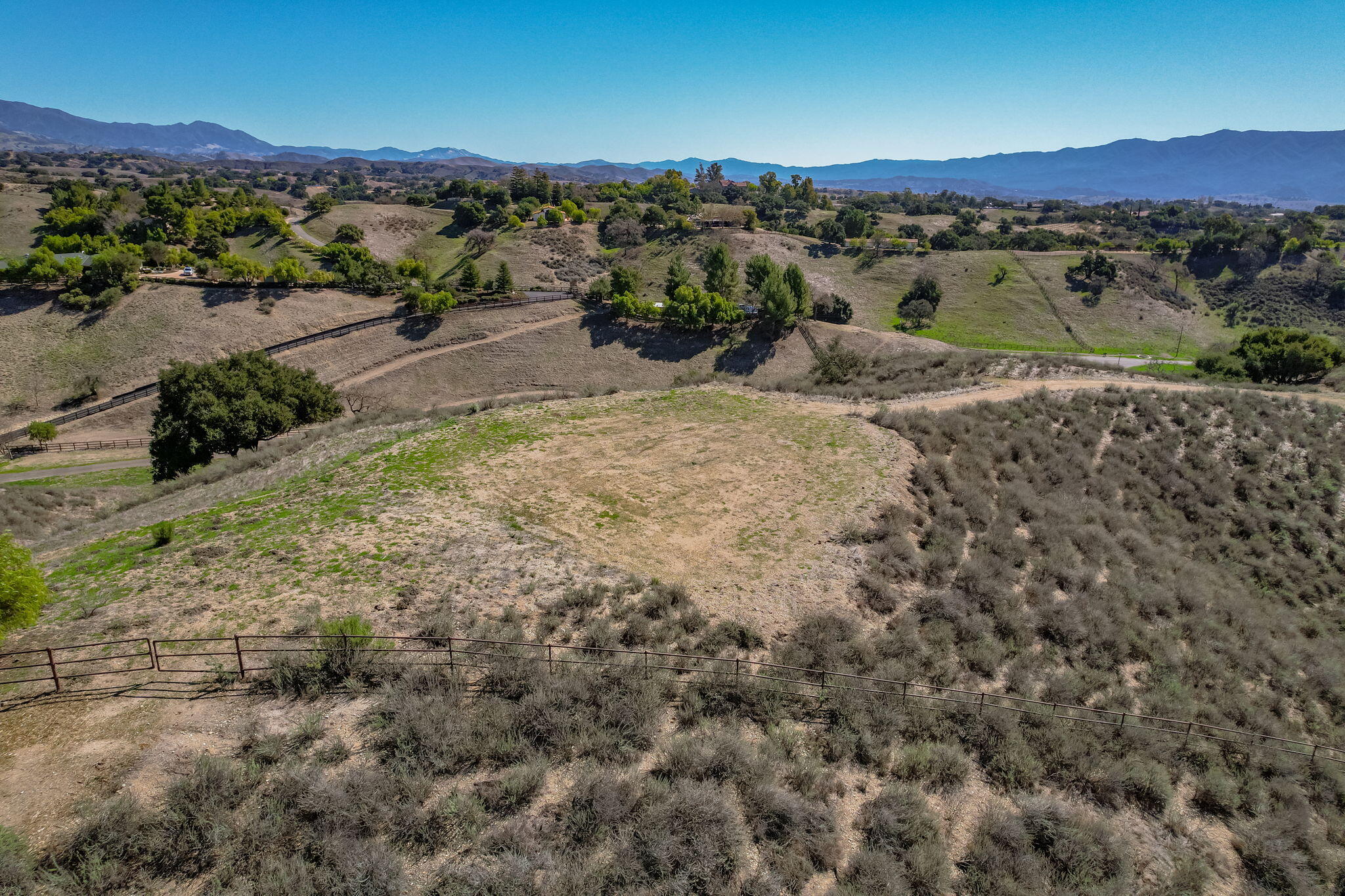 an aerial view of a houses with a yard