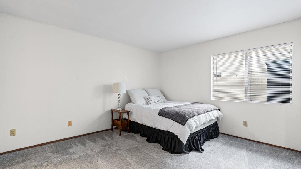 12741 Laurel Street, Unit 34 Lakeside, CA 92040 - Photo 14 of 30 a spacious bedroom with a bed and a window