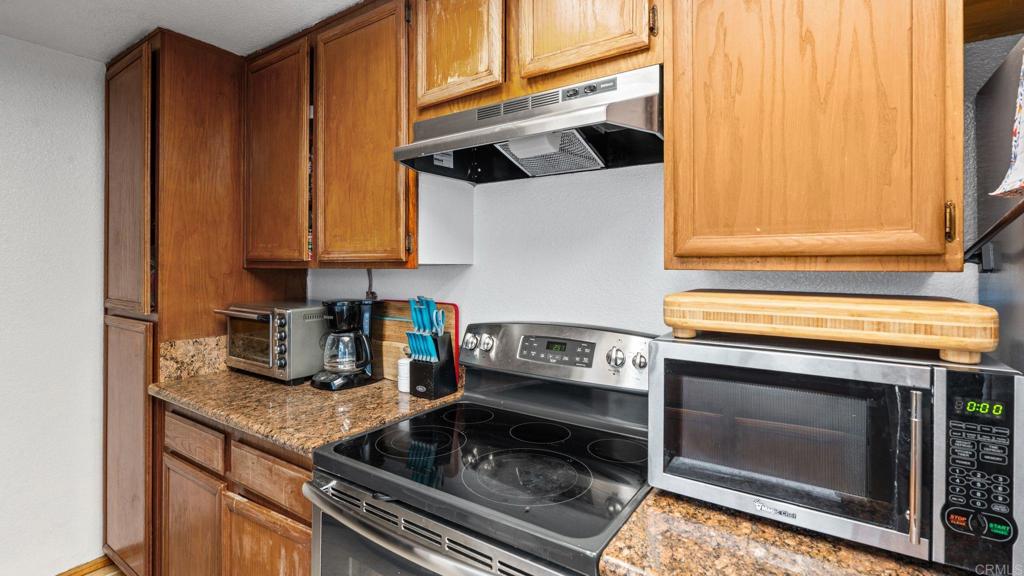 12741 Laurel Street, Unit 34 Lakeside, CA 92040 - Photo 7 of 30 a kitchen with a stove and a microwave