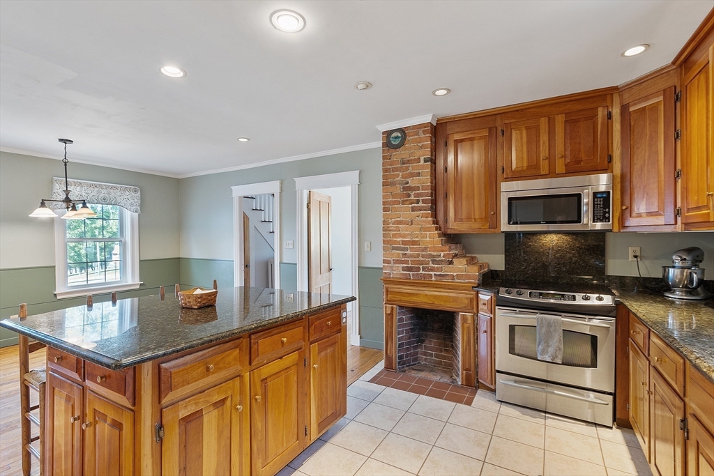 64 Central Street Gardner, MA 01440 - Photo 11 of 42 a kitchen with stainless steel appliances a stove sink microwave and cabinets