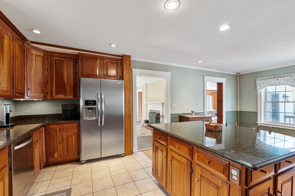 64 Central Street Gardner, MA 01440 - Photo 12 of 42 a kitchen with stainless steel appliances granite countertop a refrigerator a sink a stove with cabinets