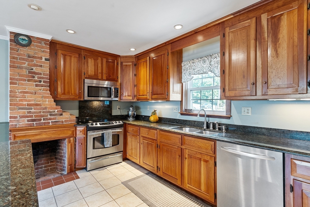 64 Central Street Gardner, MA 01440 - Photo 13 of 42 a kitchen with stainless steel appliances granite countertop a stove sink microwave and refrigerator