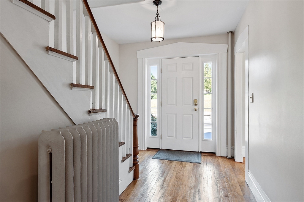 64 Central Street Gardner, MA 01440 - Photo 15 of 42 a view of a hallway with wooden floor staircase and living room