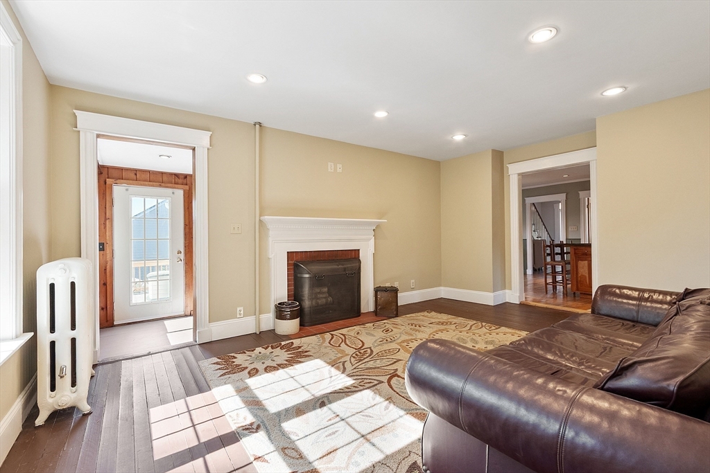 64 Central Street Gardner, MA 01440 - Photo 19 of 42 a bedroom with a bed and a fireplace