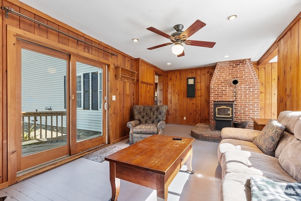 64 Central Street Gardner, MA 01440 - Photo 24 of 42 a living room with fireplace furniture and a large window