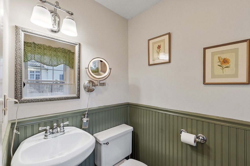 64 Central Street Gardner, MA 01440 - Photo 26 of 42 a bathroom with a toilet a sink and mirror