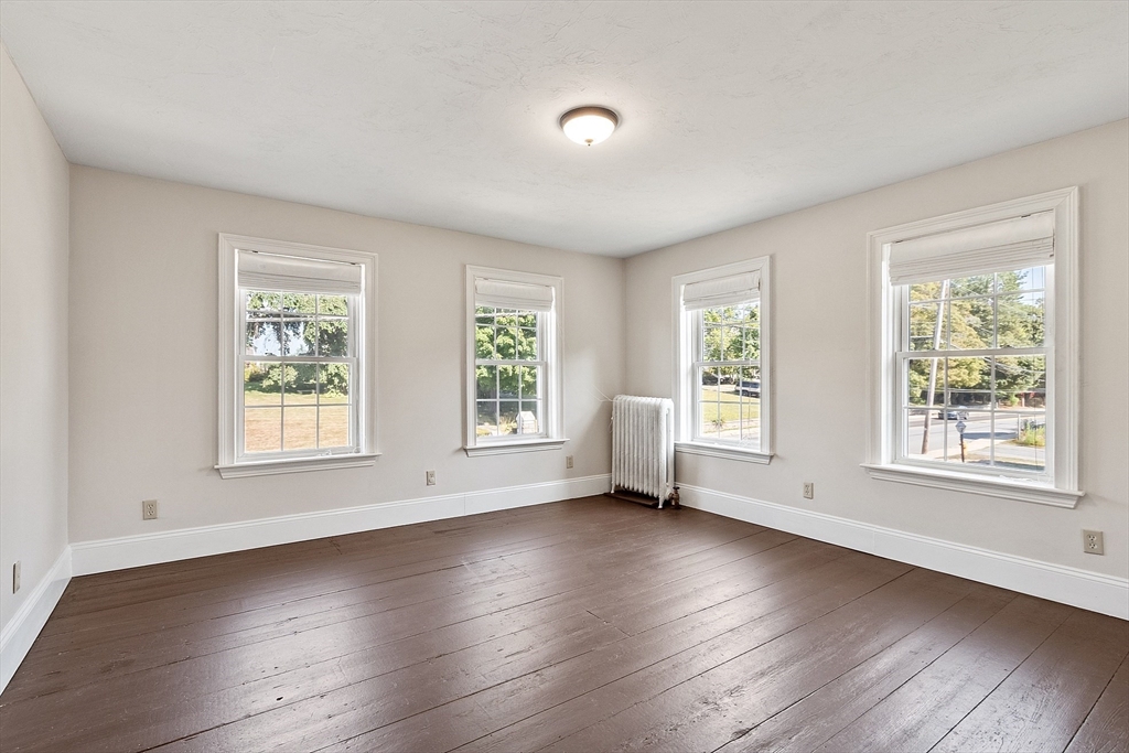 64 Central Street Gardner, MA 01440 - Photo 28 of 42 a view of an empty room with wooden floor and a window